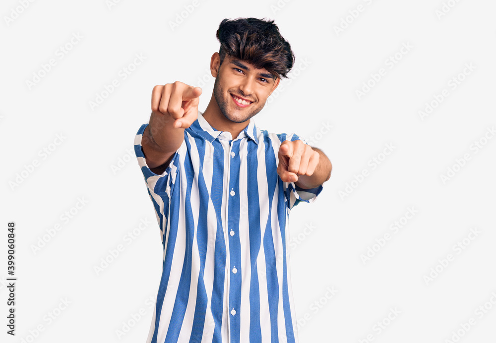 Young hispanic man wearing casual clothes pointing to you and the camera with fingers, smiling positive and cheerful Young hispanic man wearing casual clothes pointing to you and the camera with fingers, smiling positive and cheerful