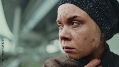 Poor, socially deprived, homeless woman crying outside, loneliness, abandonment