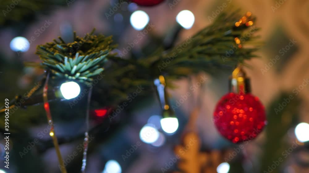 The Christmas artificial Christmas tree rotates with lights, Christmas lights. Blurred background. Flickering abstract colored circles defocused christmas lights video. Blurry fairy lights The Christmas artificial Christmas tree rotates with lights, Christmas lights. Blurred background. Flickering abstract colored circles defocused christmas lights video. Blurry fairy lights