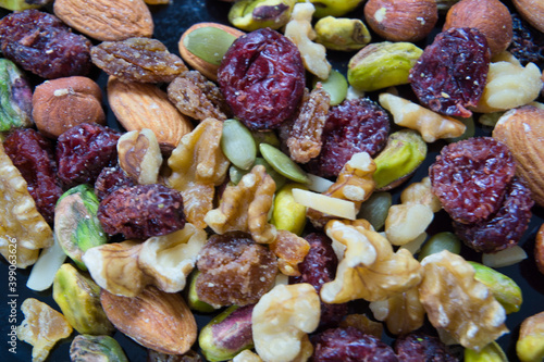 Mixed nuts, heart healthy food on a wooden background. Top view.