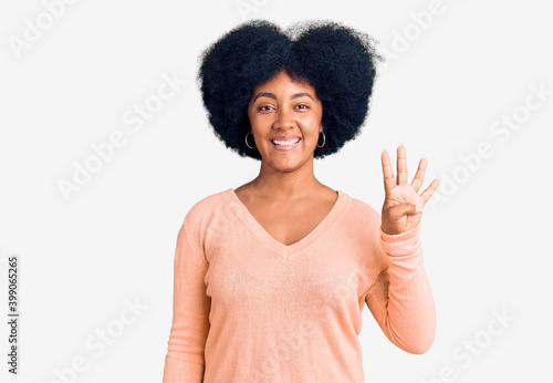 Young african american girl wearing casual clothes showing and pointing up with fingers number four while smiling confident and happy.