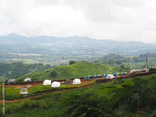 Mountain accommodations where the accommodations are white and the mountain views are green.
