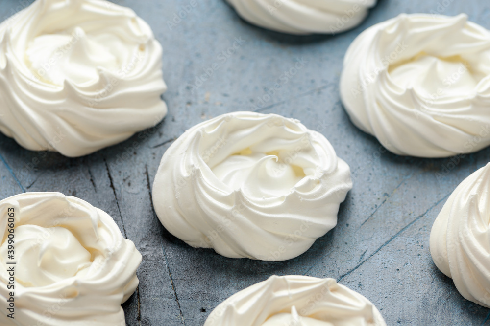 Sweet white meringue on old rustic table Sweet white meringue on old rustic table