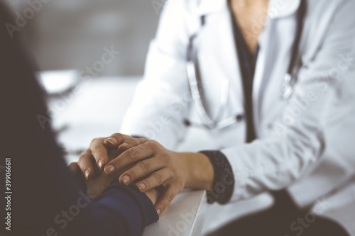 Unknown woman-doctor is reassuring her female patient  close-up. Physician is consulting and giving some advices to a woman. Concepts of medical ethics and trust. Empathy in medicine