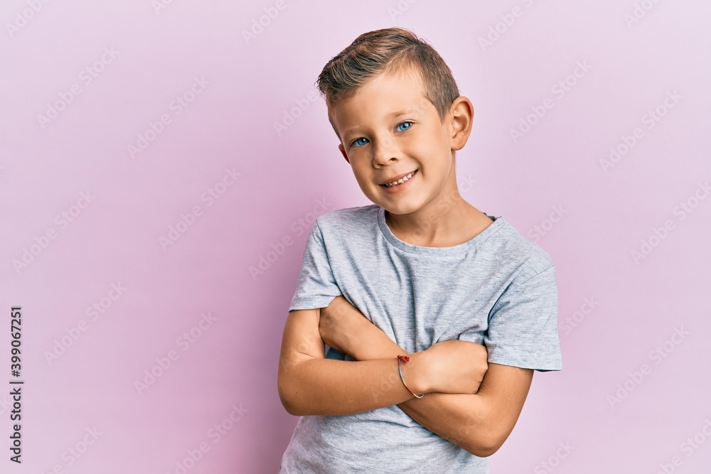 Adorable caucasian kid wearing casual clothes happy face smiling with crossed arms looking at the camera. positive person. Adorable caucasian kid wearing casual clothes happy face smiling with crossed arms looking at the camera. positive person.