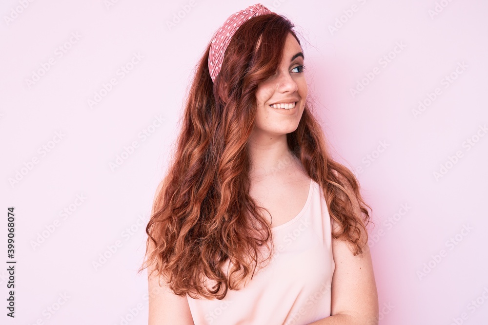 Young beautiful woman wearing casual clothes looking away to side with smile on face, natural expression. laughing confident. Young beautiful woman wearing casual clothes looking away to side with smile on face, natural expression. laughing confident.