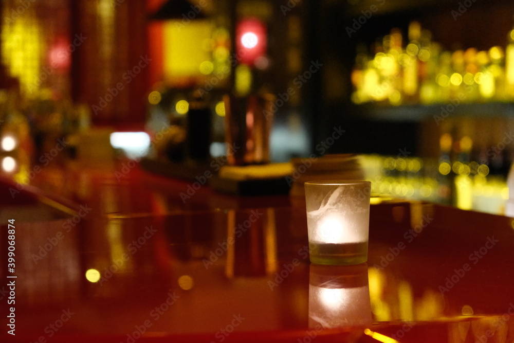 close up one candle light on night bar counter. blur background