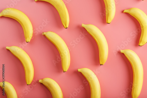 Bright pattern of yellow bananas on a pink background.
