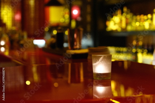 close up one candle light on night bar counter. blur background