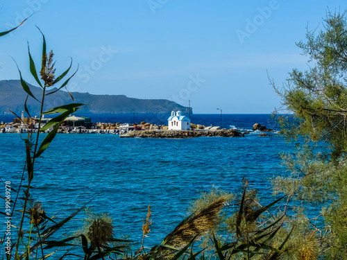 Fototapeta Naklejka Na Ścianę i Meble -  A glimpse of  the Marine Down Galata chapel on a peninsula near Chania, Crete on a bright sunny day