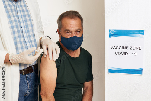 Elderly people with preexisting conditions are vaccinated against Covid-19 by social security medical personnel. Coronavirus Vaccine photo