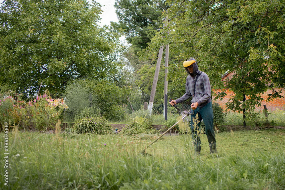 Man mowing the lawn in his garden. Gardener cutting the grass. Lifestyle. Man mowing the lawn in his garden. Gardener cutting the grass. Lifestyle.