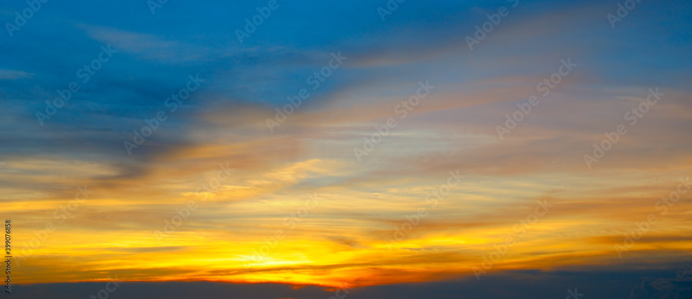 Beautiful sunset sky above clouds with dramatic light. Wide photo.