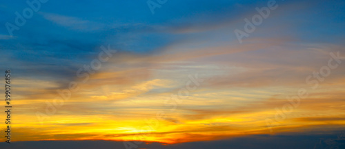 Beautiful sunset sky above clouds with dramatic light. Wide photo. © alinamd