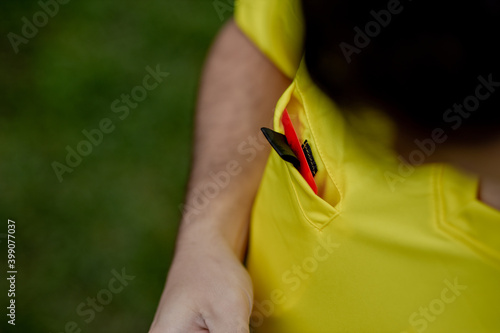 Referee showing a red card to a displeased football or soccer player while gaming. Concept of sport  rules violation  controversial issues  obstacles overcoming.