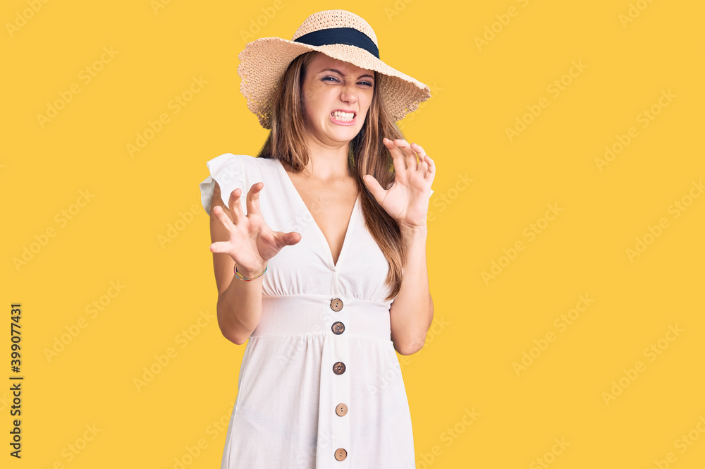 Young beautiful blonde woman wearing summer dress and hat disgusted expression, displeased and fearful doing disgust face because aversion reaction. with hands raised Young beautiful blonde woman wearing summer dress and hat disgusted expression, displeased and fearful doing disgust face because aversion reaction. with hands raised