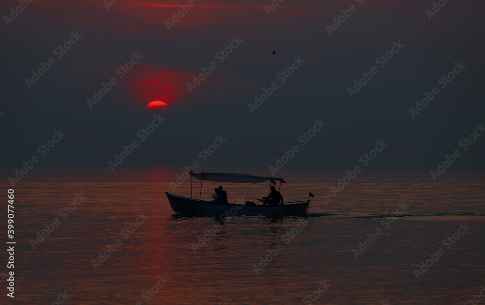 Sightseeing boats at sunset.
