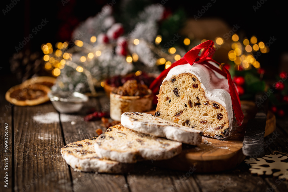 Christmas Stollen. Traditional Sweet Fruit Loaf with Icing Sugar. Xmas holiday table setting.