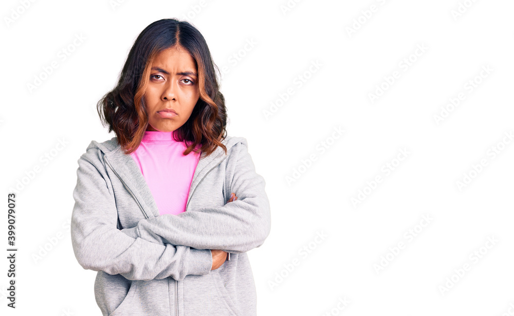Young beautiful mixed race woman wearing casual sporty clothes skeptic and nervous, disapproving expression on face with crossed arms. negative person. Young beautiful mixed race woman wearing casual sporty clothes skeptic and nervous, disapproving expression on face with crossed arms. negative person.