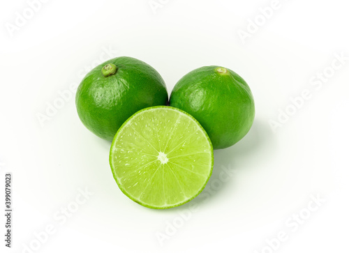 Ripe slice of green lime citrus fruit stand isolated on white background. Lime wedge. vegan food concept
