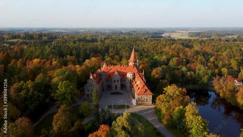 Cesvaine Medieval Castle in Latvia From Above Top View. A Manor House of the Late 19th Century, a Building of Stones With a Brown Tiled Roof. Cesvaine Palace in Beautiful Autumn Day. Aerial Dron 4k S Cesvaine Medieval Castle in Latvia From Above Top View. A Manor House of the Late 19th Century, a Building of Stones With a Brown Tiled Roof. Cesvaine Palace in Beautiful Autumn Day. Aerial Dron 4k S