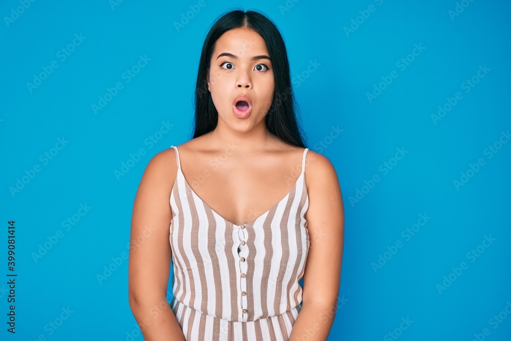 Young beautiful asian girl wearing casual clothes afraid and shocked with surprise expression, fear and excited face. Young beautiful asian girl wearing casual clothes afraid and shocked with surprise expression, fear and excited face.