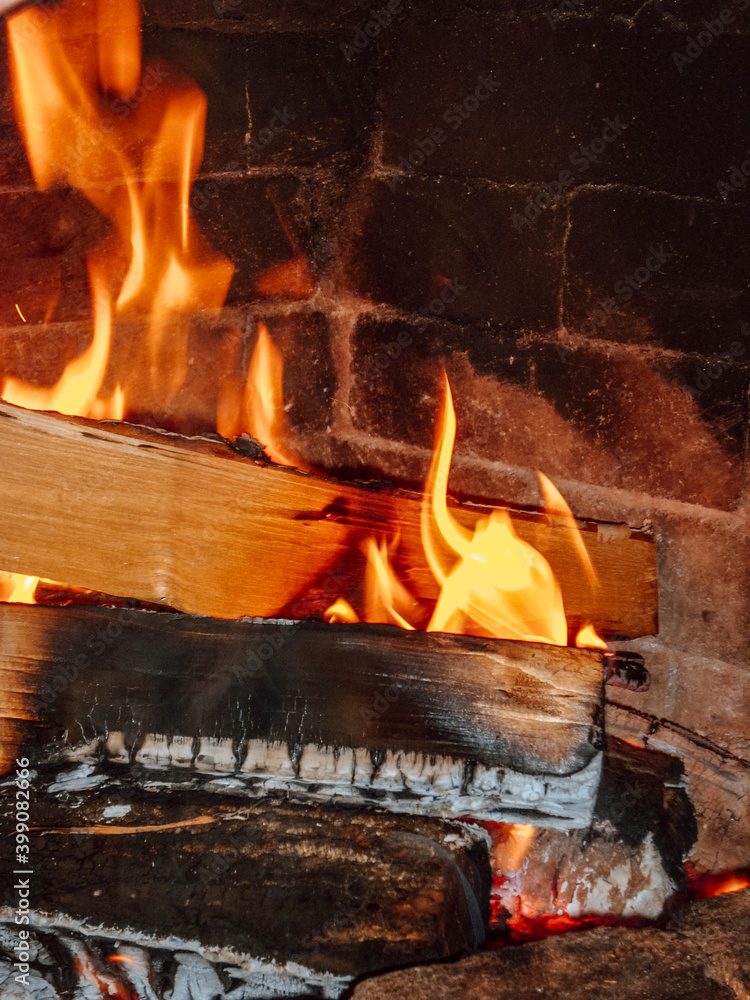 Fireplace with burning firewood. Firewood in the hearth Fireplace with burning firewood. Firewood in the hearth