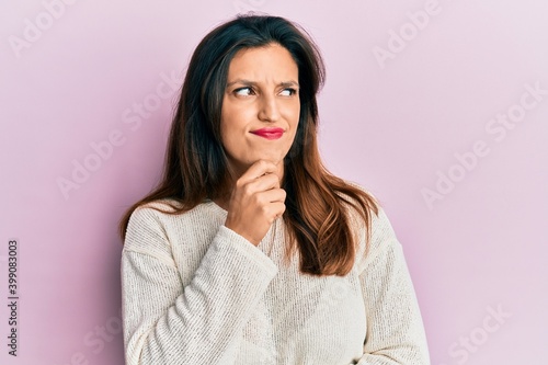 Beautiful hispanic woman wearing casual clothes thinking concentrated about doubt with finger on chin and looking up wondering © Krakenimages.com