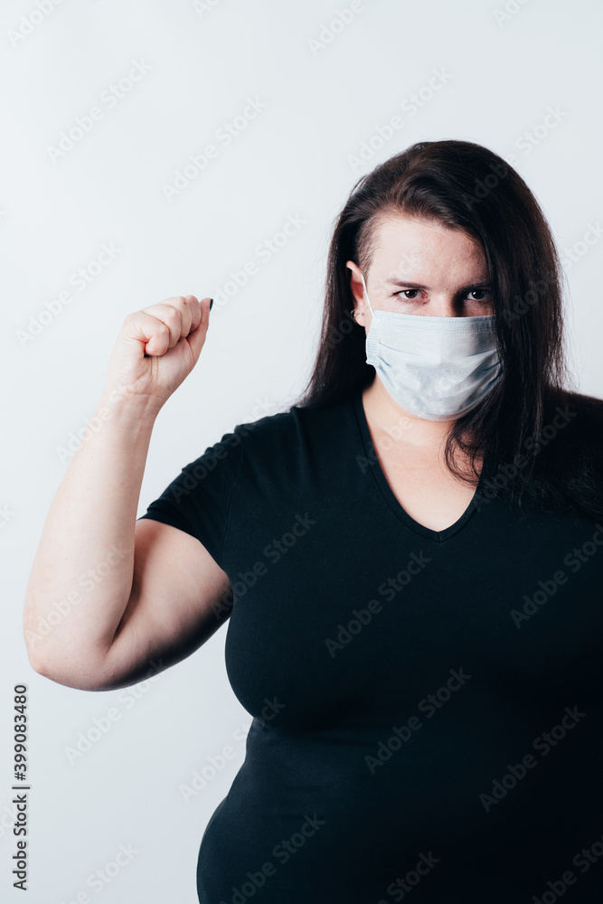 Woman wearing a face mask making a win gesture Woman wearing a face mask making a win gesture