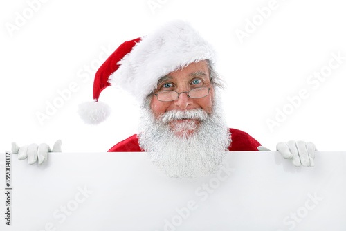 Santa Claus standing behind a white sign
