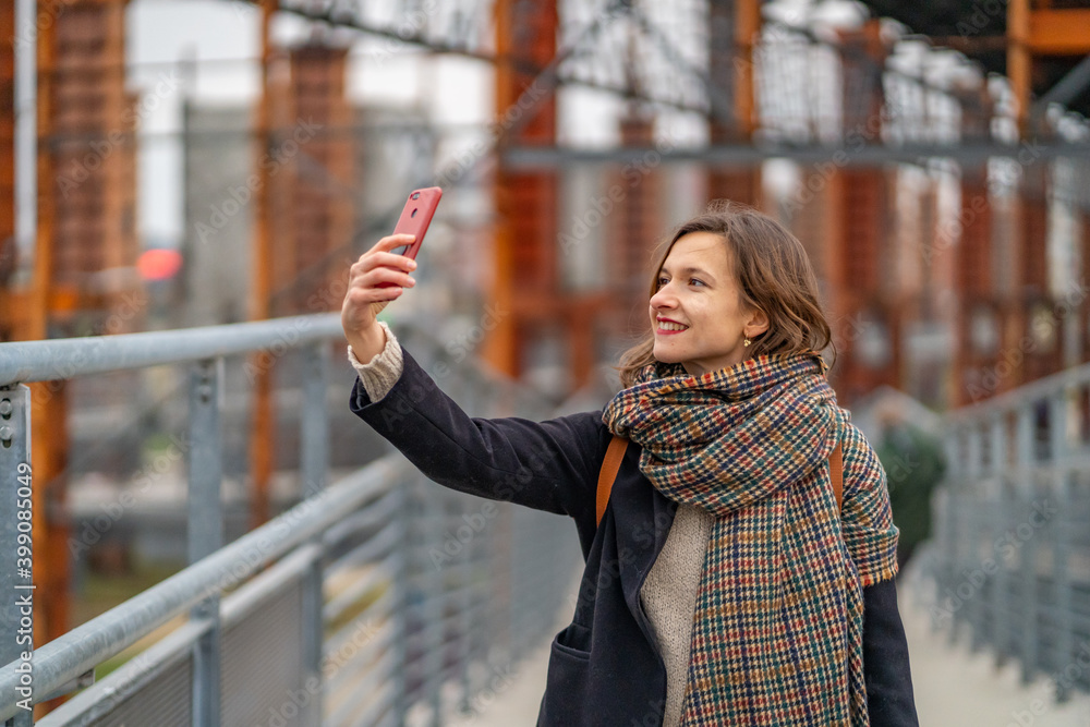 beautiful girl woman walking in Torino and taking selfie near Parco Dora, the large urban park in Turin, Italy beautiful girl woman walking in Torino and taking selfie near Parco Dora, the large urban park in Turin, Italy