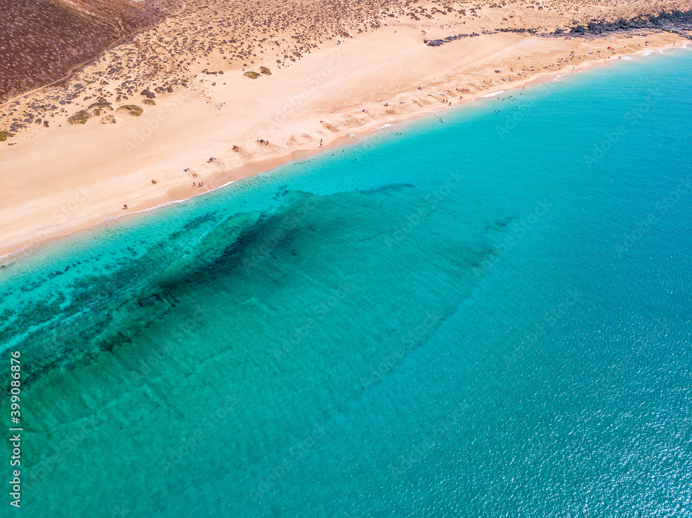 Aerial view of the jagged shores and beaches of La Graciosa island. Bathers on the beach of las Conchas. The main archipelago island Chinijo, a mile northwest of Lanzarote. Canary island. Spain. Ocean