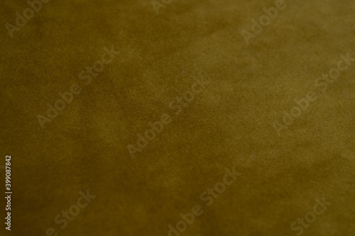 Golden mustard colored velvet background. Soft fabric backdrop. photo