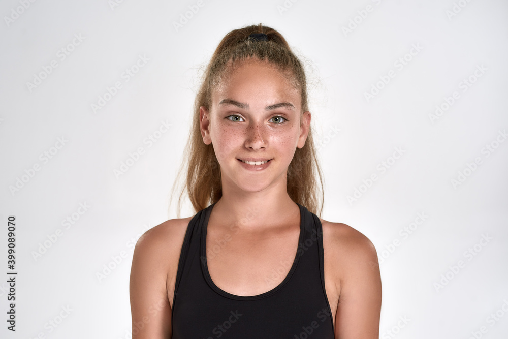 Portrait of cute sportive girl child in sportswear smiling at camera while posing isolated over white background Portrait of cute sportive girl child in sportswear smiling at camera while posing isolated over white background