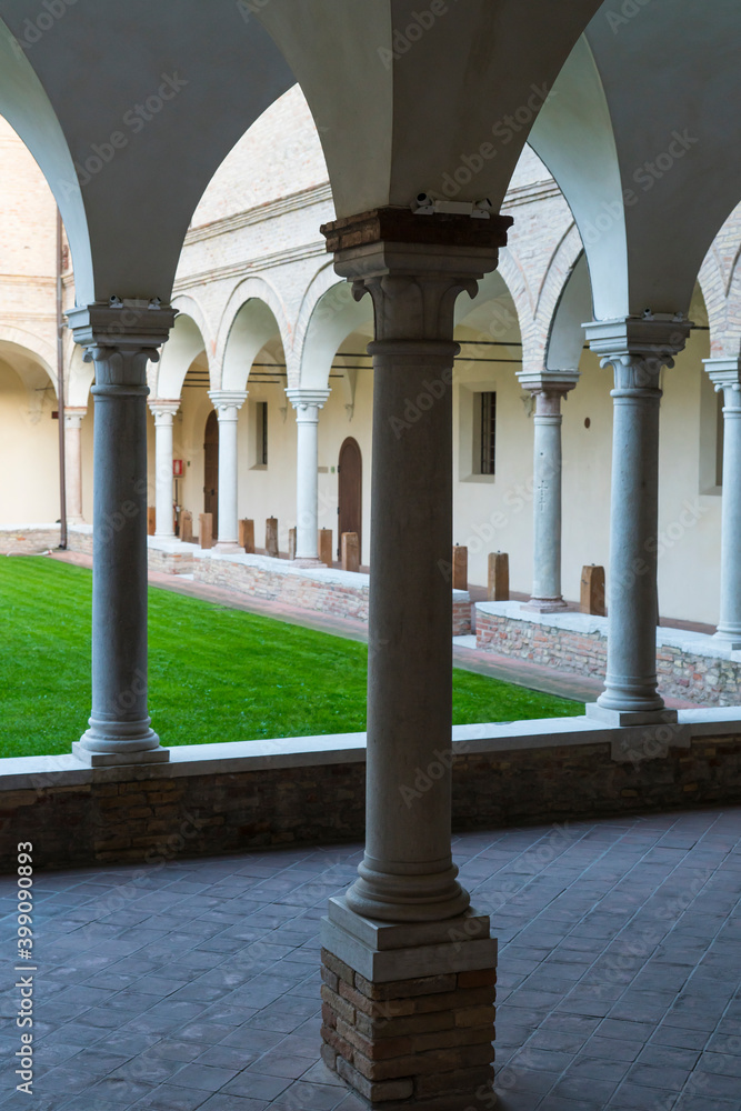 arches and green lawn of old Franciscan friars cloister. Ravenna, Italy
