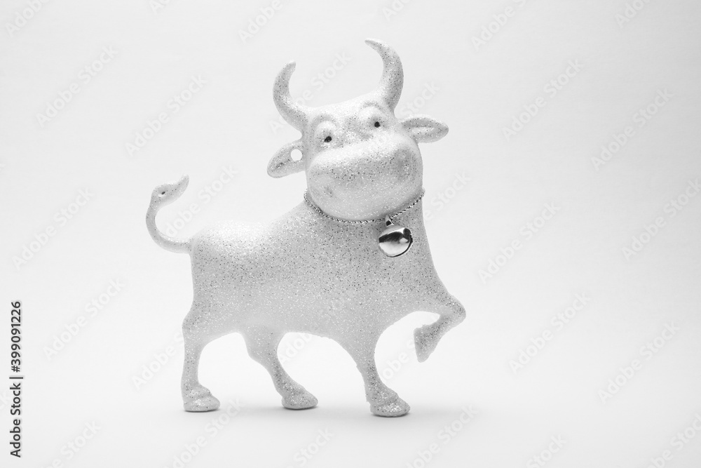 Christmas toy of a cheerful white bull on a white background