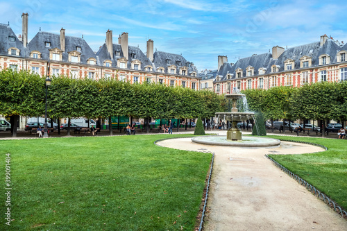 The Square of Vosges in Paris with fountains and painted facade