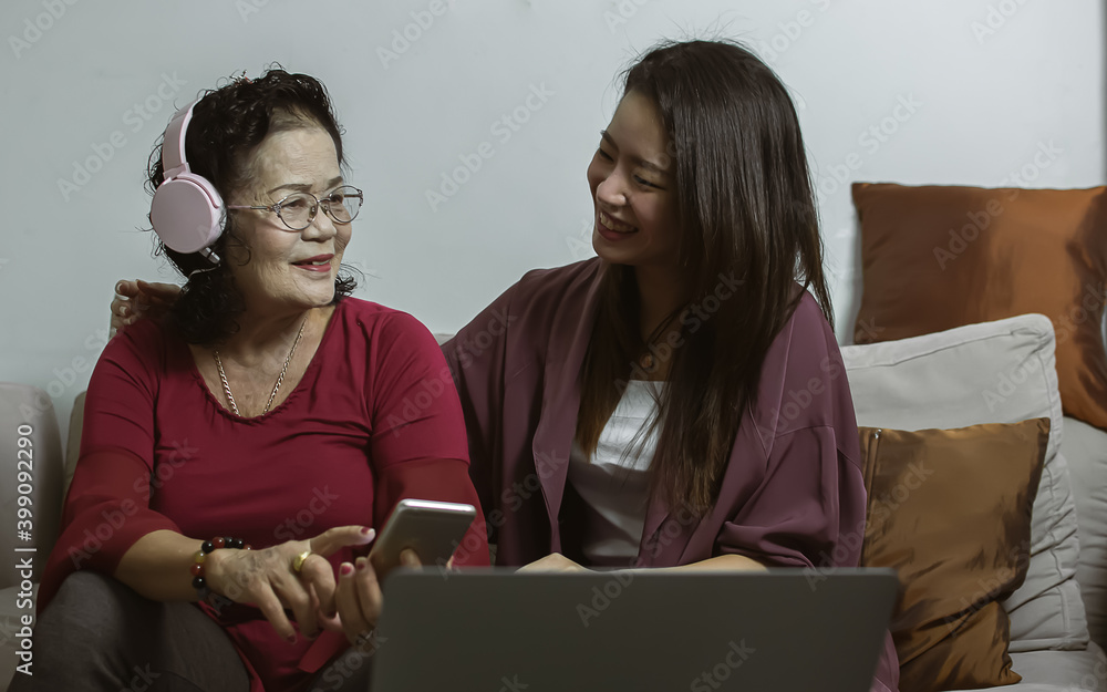 Old and young women relaxing at home together Old and young women relaxing at home together