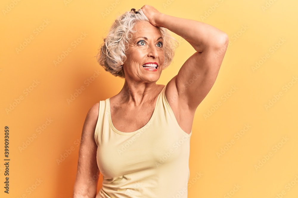 Senior grey-haired woman wearing casual clothes smiling confident touching hair with hand up gesture, posing attractive and fashionable Senior grey-haired woman wearing casual clothes smiling confident touching hair with hand up gesture, posing attractive and fashionable