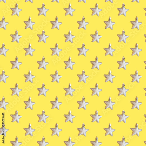 seamless pattern with grey metallic stars on yellow illuminating background