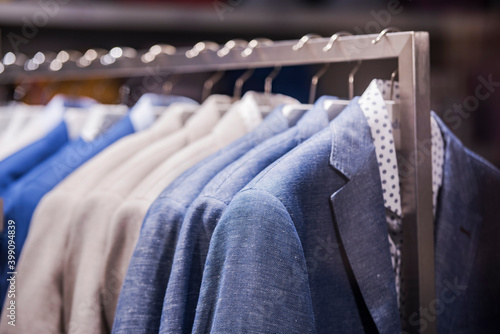 men clothing on hanger in a shop - shopping in mall concept