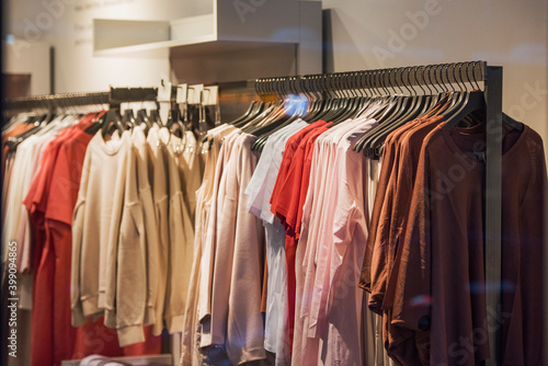 Women clothing on hangers in a mall - shopping in mall concept © agcreativelab
