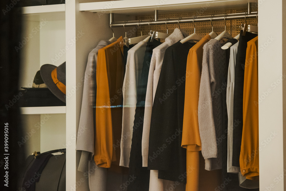 Women clothing on hangers in a mall - shopping in mall concept Women clothing on hangers in a mall - shopping in mall concept