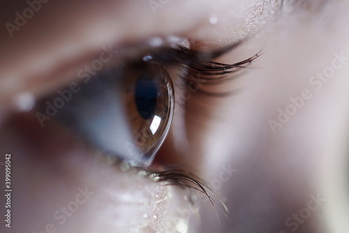side view of brown eye, open sparkling eye looking forward, close up