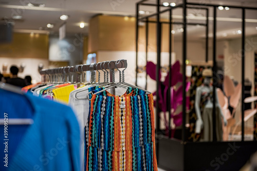 Women clothing on hangers in a mall - shopping in mall concept