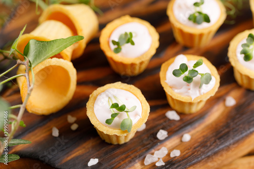 Canapes with light cream filling. Still life with microgreens. The concept of an appetizing snack.