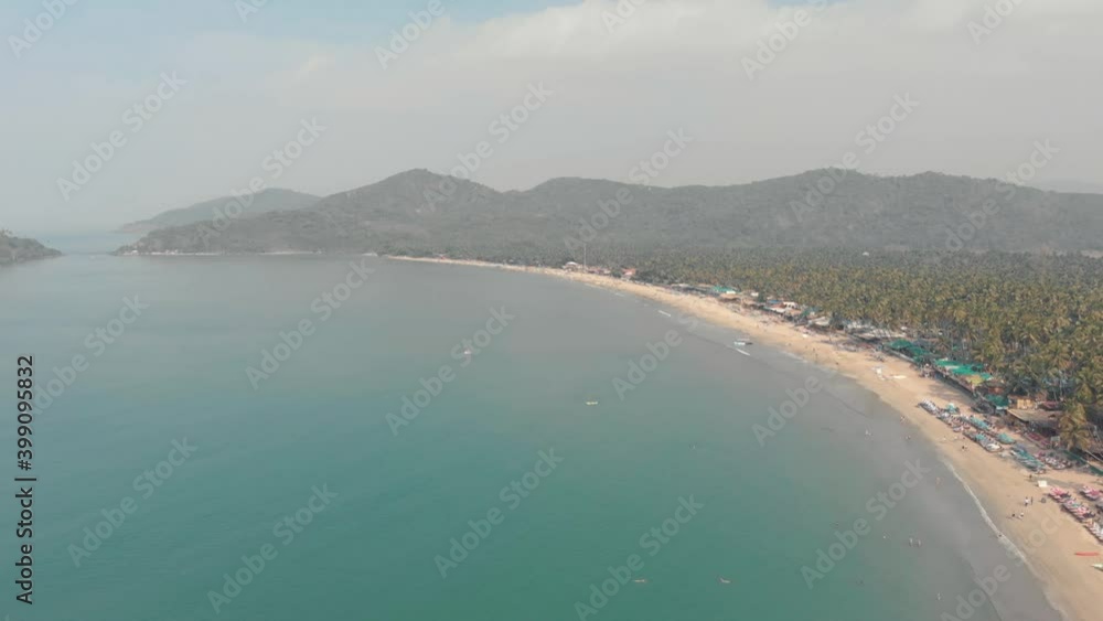 Turquoise ocean shore in Palolem Beach in southern Goa, India - Aerial Wide shot Turquoise ocean shore in Palolem Beach in southern Goa, India - Aerial Wide shot