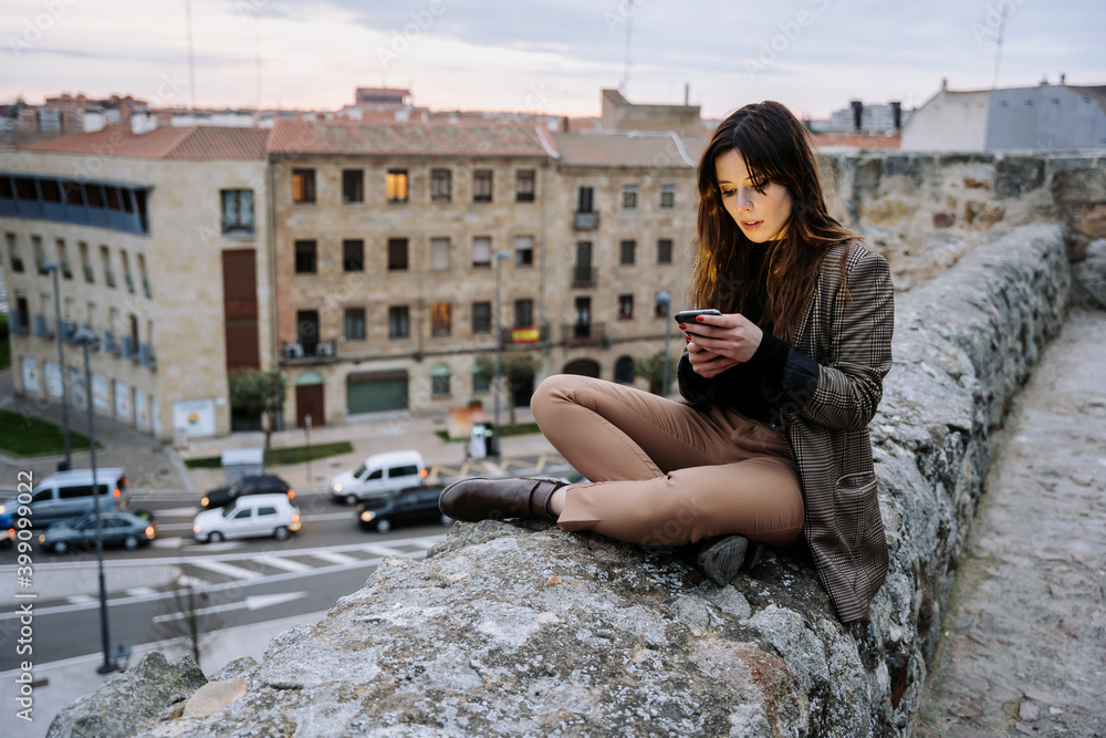 Girl watching a phone in a city