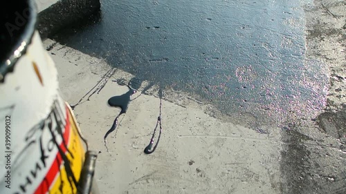 Roofer team lay black roofing material on white flat roof. Aerial view pattern texture concrete