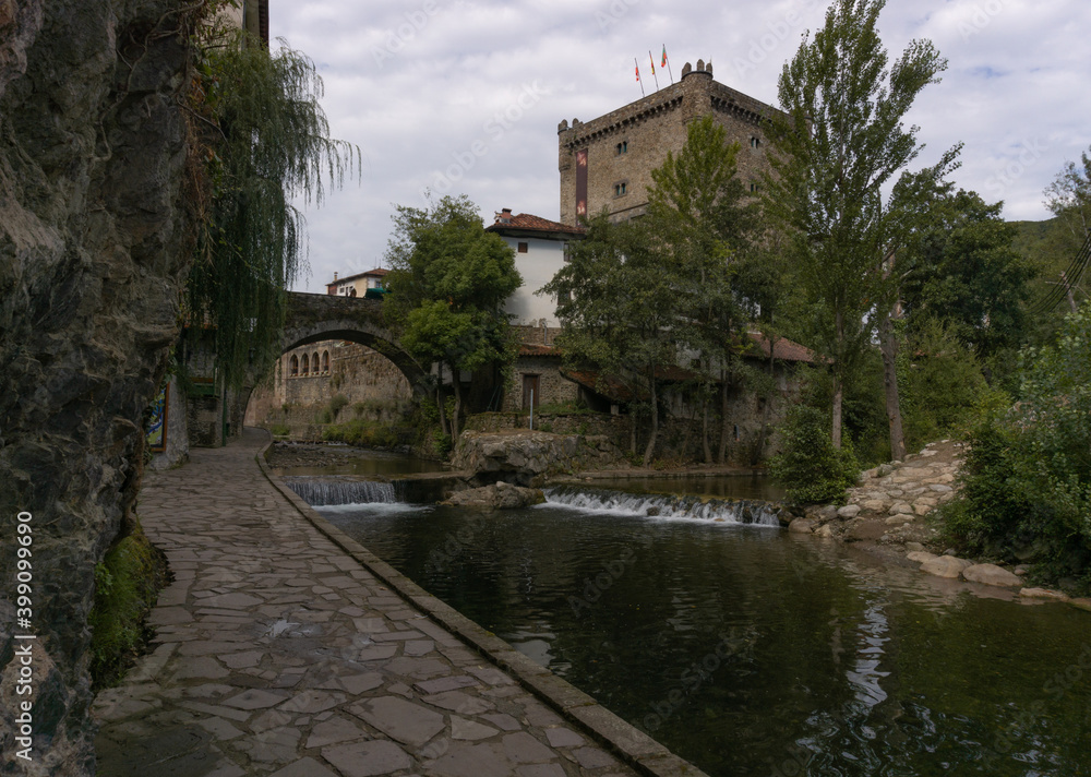 Walk along the river side that passes through the medieval town of Potes in the Picos de Europa, in Cantabria in the Liebana Valley in northern Spain.